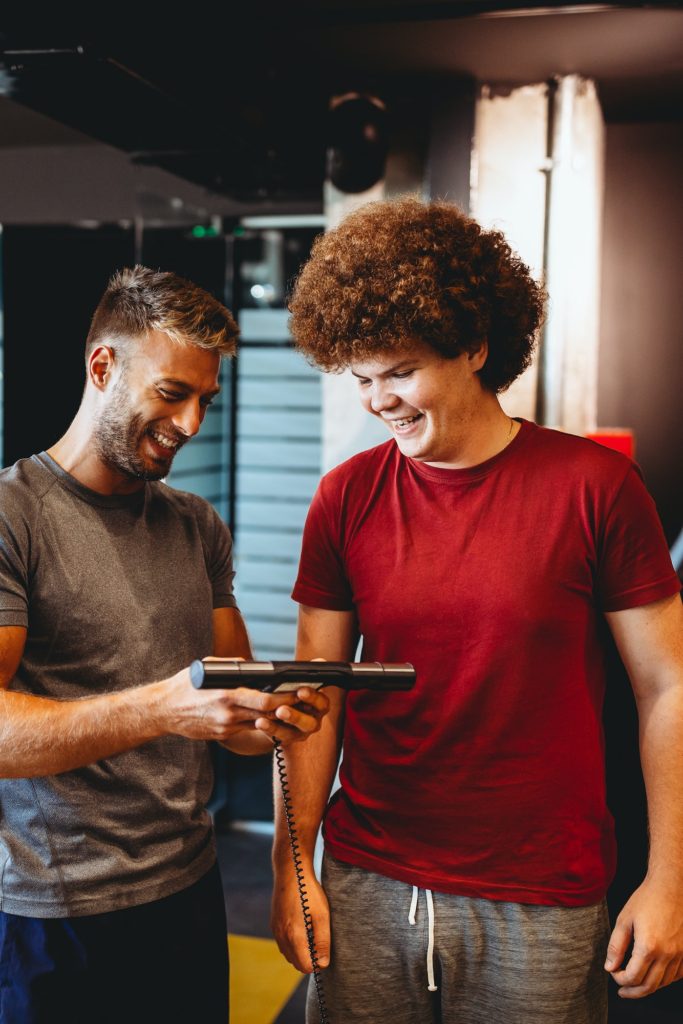 Happy overweight man with personal trainer, achieve goals, success