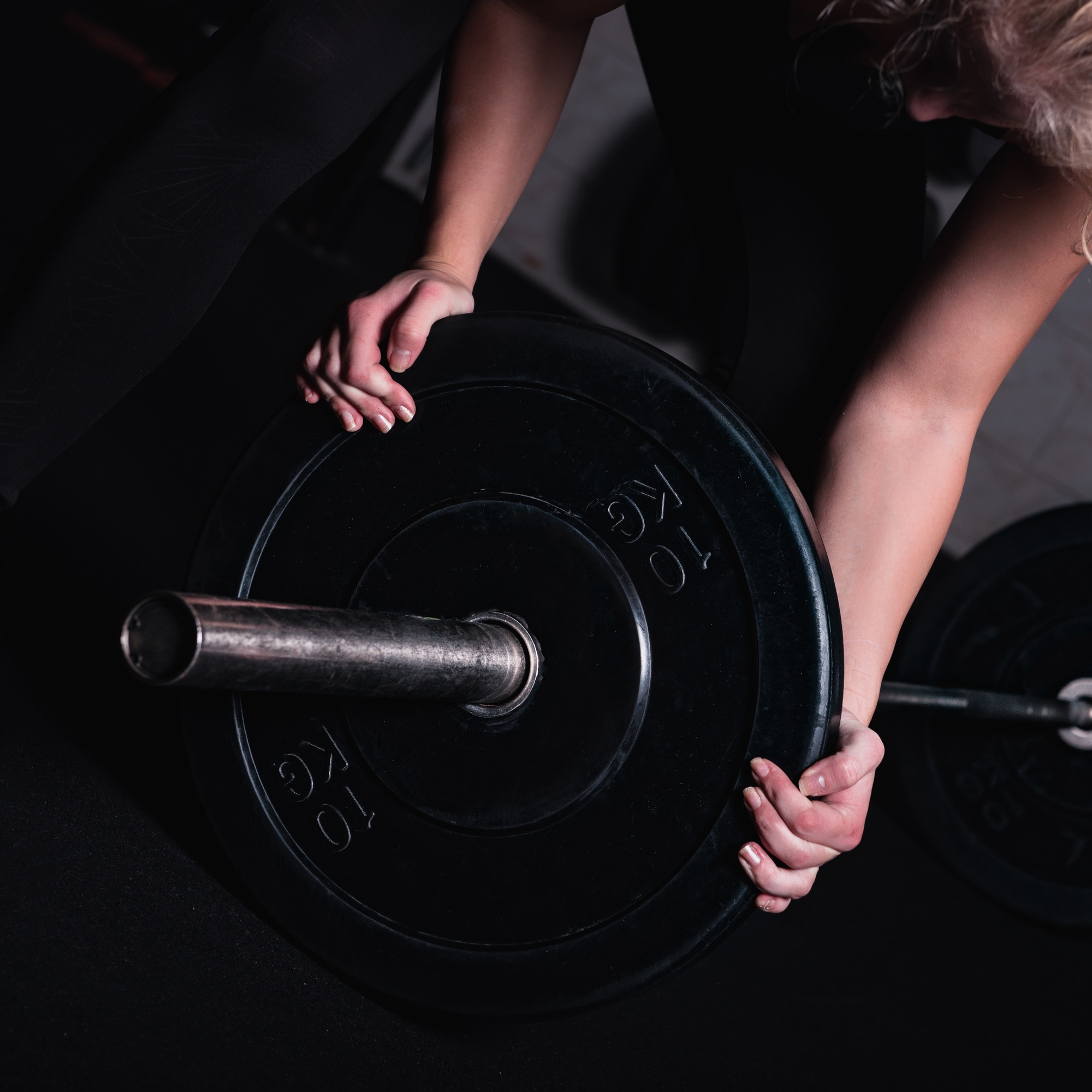 Sporty Woman With Barbell In A Gym